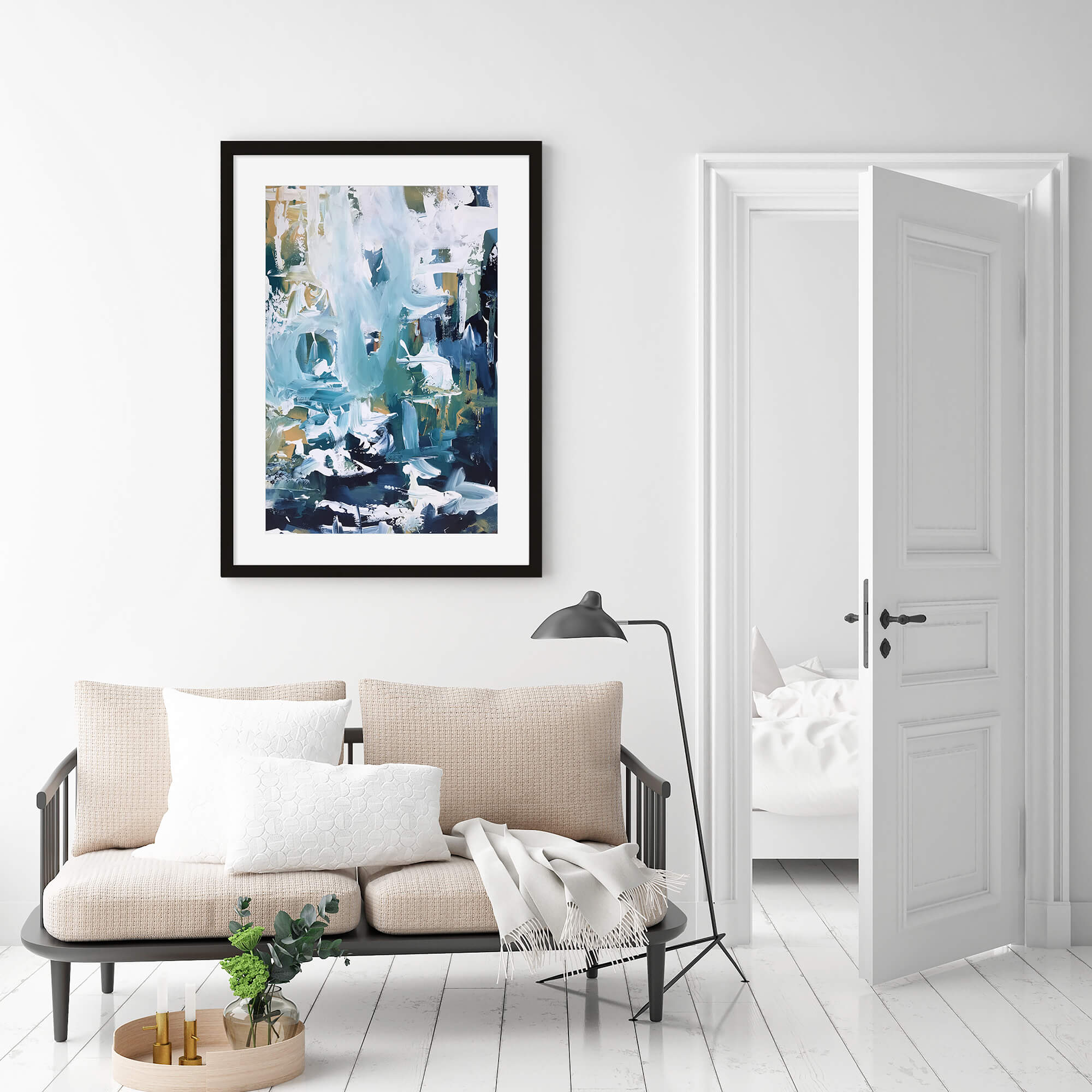 a framed print on a wall above a sofa in a living room