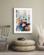 a large framed art print on a beige wall in a modern styled room