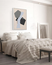 Modern bedroom with a bed, abstract art on the wall, and a bench.