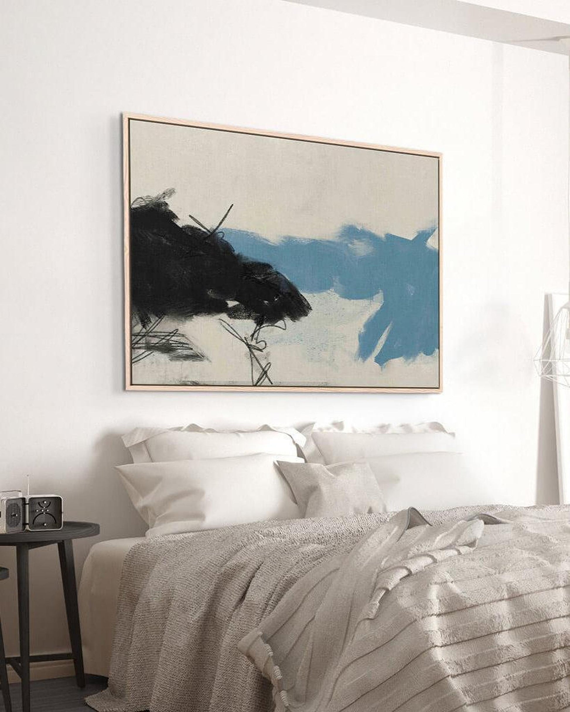 Modern bedroom with abstract art above a bed