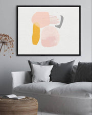 A canvas print featuring an abstract design with modern pink, white, and yellow tones, framed and ready to hang.